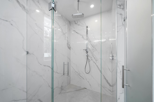 full bathroom with a marble finish shower