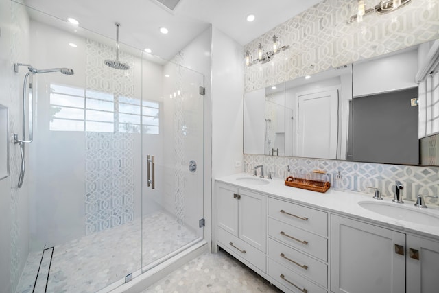 full bath with decorative backsplash, a stall shower, and a sink