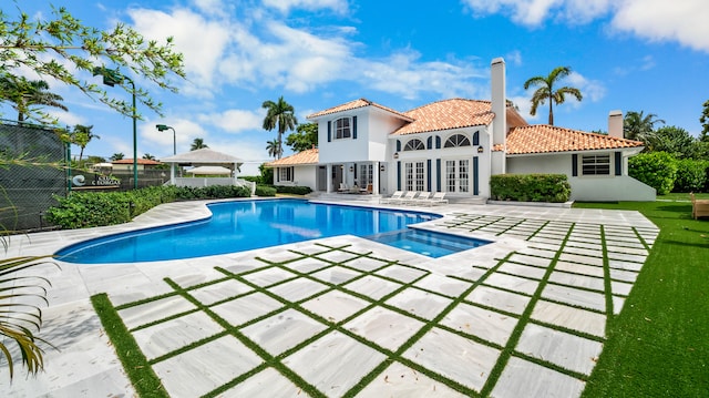 view of swimming pool with french doors and a patio