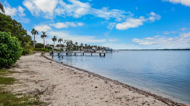 dock area featuring a water view and a view of the beach