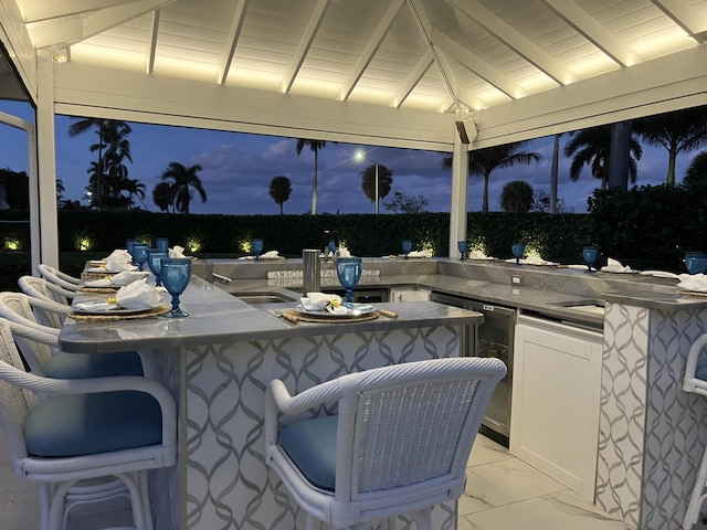 7515-7425 S Flagler Dr, West Palm Beach, FL 33405 - patio at night with wine cooler and exterior kitchen