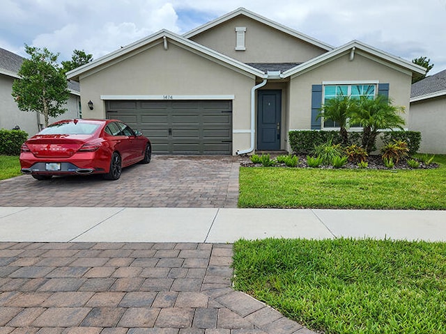 view of front facade with a garage and a front yard