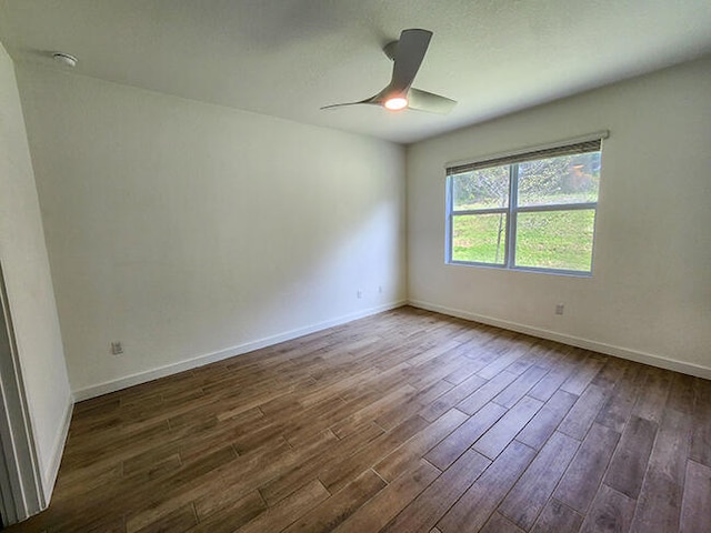 unfurnished room with dark hardwood / wood-style floors and ceiling fan