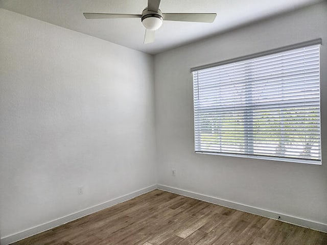 empty room with wood-type flooring and ceiling fan