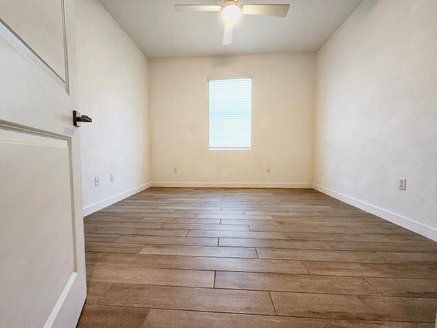 unfurnished room featuring ceiling fan and light hardwood / wood-style flooring