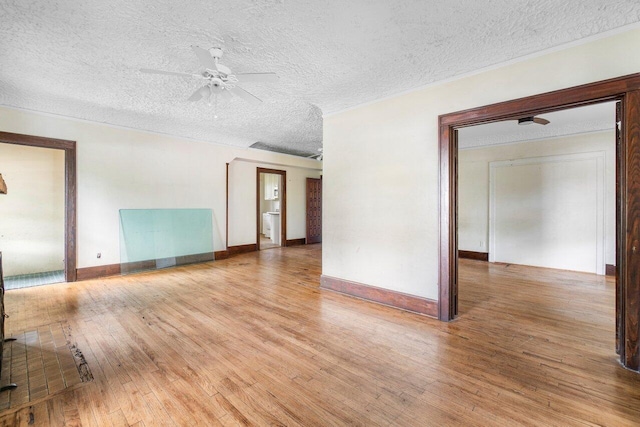 empty room featuring ceiling fan, a textured ceiling, and light wood-type flooring