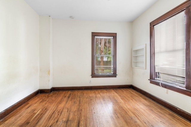 empty room with hardwood / wood-style flooring