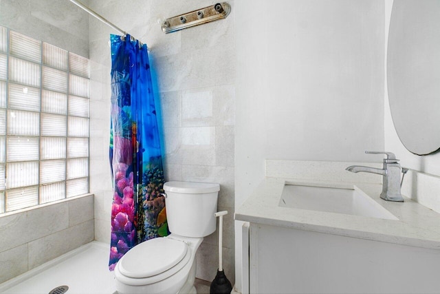 bathroom with tile walls, vanity, toilet, and a shower with curtain