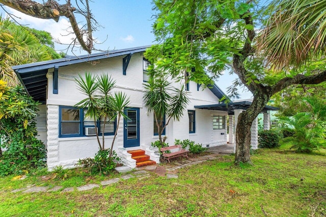 view of front of house featuring a front yard and cooling unit