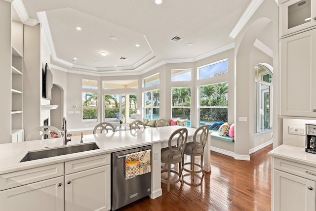 kitchen with dark hardwood / wood-style floors, sink, a healthy amount of sunlight, and dishwasher