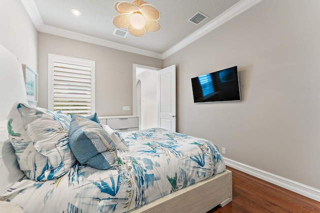 bedroom featuring ceiling fan, crown molding, and hardwood / wood-style floors