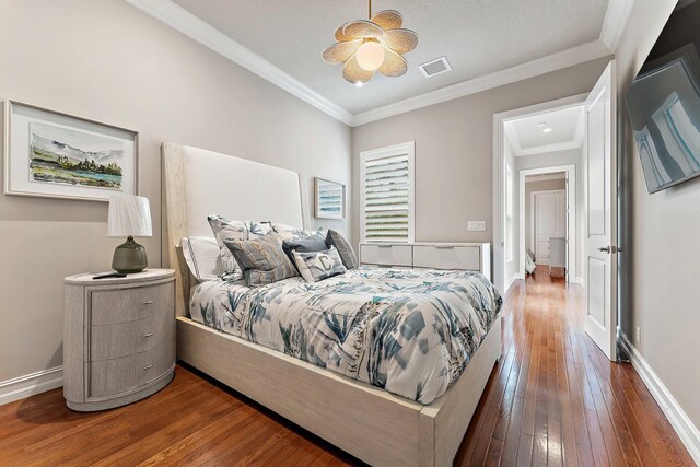 bedroom featuring ceiling fan, crown molding, and dark hardwood / wood-style floors