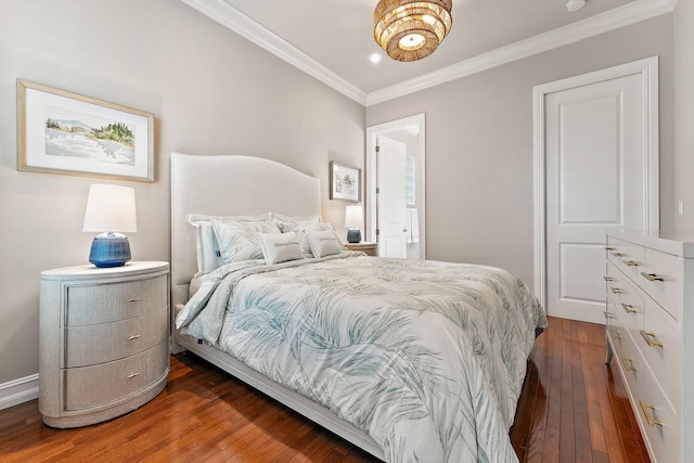 bedroom with ornamental molding and dark hardwood / wood-style flooring