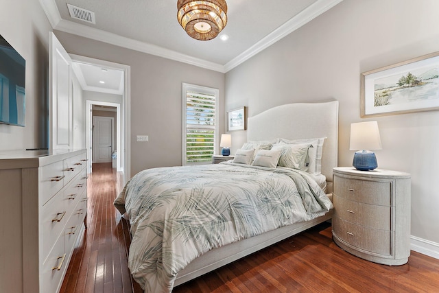 bedroom featuring ornamental molding and dark hardwood / wood-style flooring