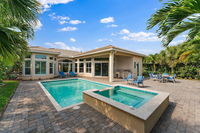 view of pool featuring a patio area and an in ground hot tub