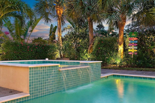 view of pool at dusk