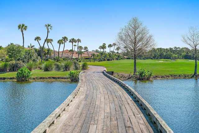 view of community featuring a lawn and a water view