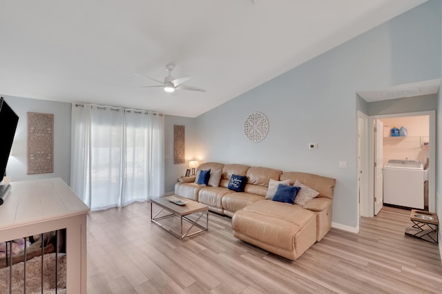 living room featuring light hardwood / wood-style floors, ceiling fan, and washer / dryer