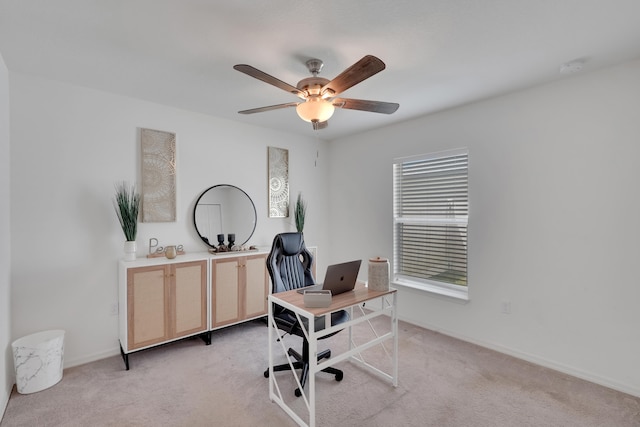 office area featuring light carpet and ceiling fan