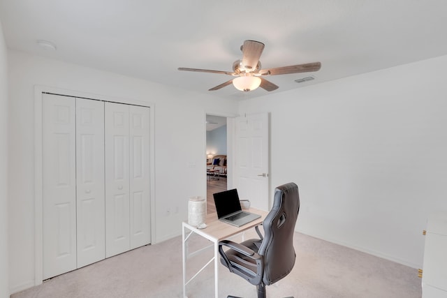 carpeted home office with ceiling fan