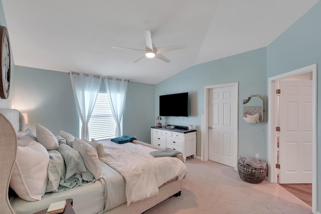 bedroom with ceiling fan, lofted ceiling, and light carpet