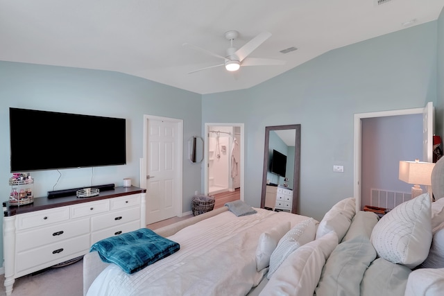 carpeted bedroom with connected bathroom, vaulted ceiling, and ceiling fan