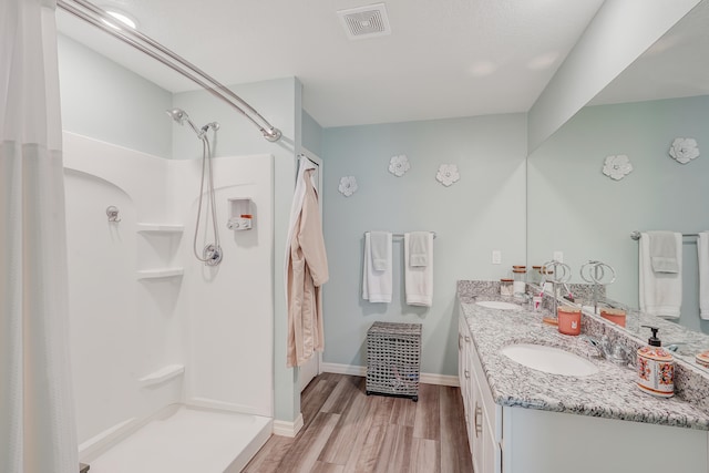 bathroom featuring hardwood / wood-style flooring, vanity, and a shower with curtain