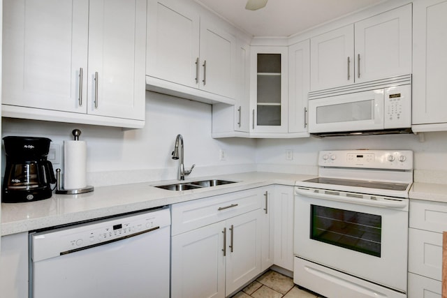 kitchen with glass insert cabinets, white appliances, white cabinetry, and a sink