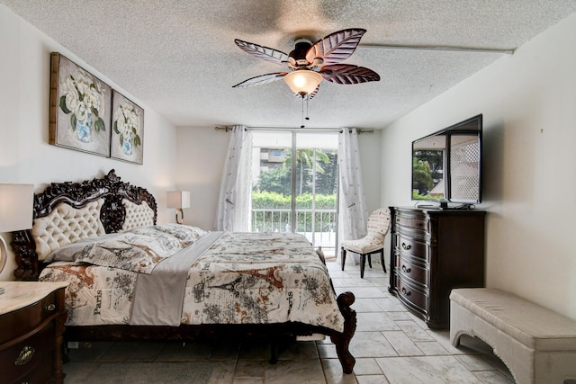 bedroom with a textured ceiling, access to outside, and a ceiling fan