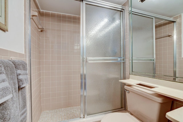 full bath featuring a shower stall and toilet