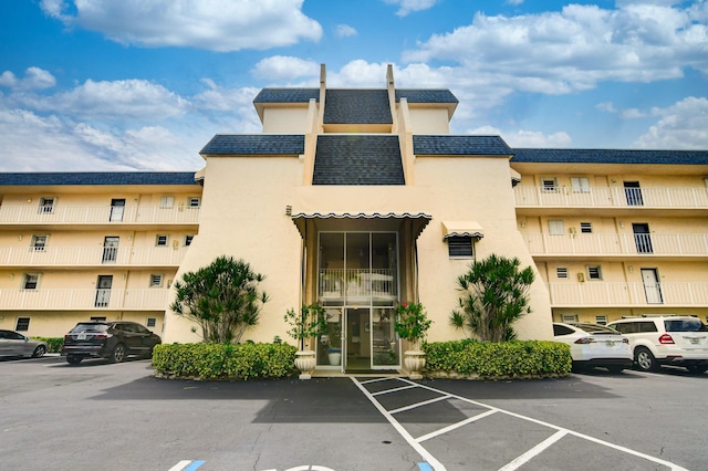 view of property featuring uncovered parking