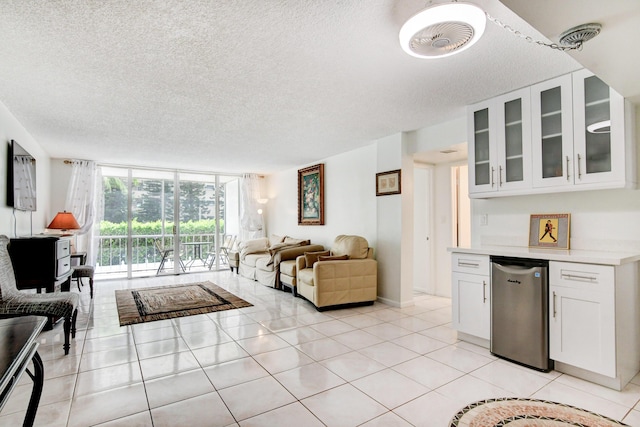 living room with a dry bar, light tile patterned floors, expansive windows, and a textured ceiling