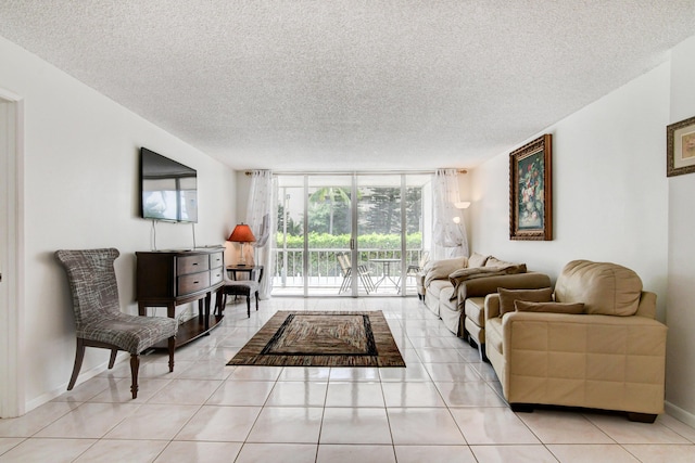 living room featuring expansive windows, a textured ceiling, baseboards, and light tile patterned floors