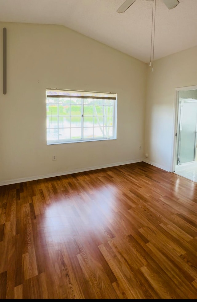 empty room featuring lofted ceiling, ceiling fan, and dark hardwood / wood-style flooring