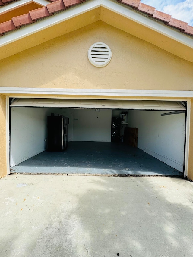 garage with stainless steel refrigerator