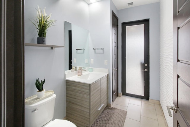 bathroom featuring tile patterned flooring, vanity, and toilet