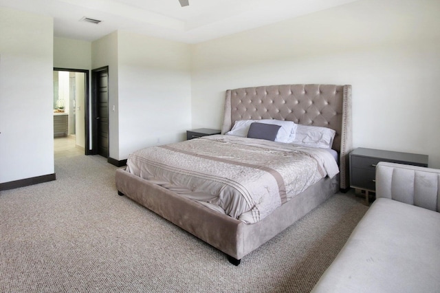 carpeted bedroom featuring ceiling fan and ensuite bath