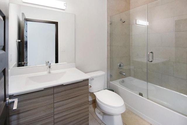 full bathroom with shower / bath combination with glass door, toilet, vanity, and tile patterned floors