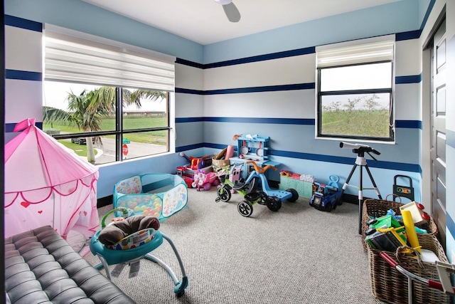 playroom with ceiling fan and carpet flooring