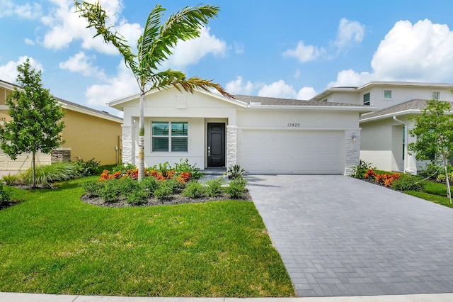 view of front of property featuring a garage and a front lawn