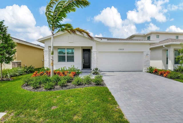 view of front of home featuring a front lawn and a garage