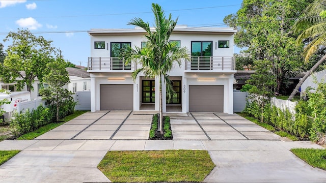 view of front of home featuring a balcony and a garage