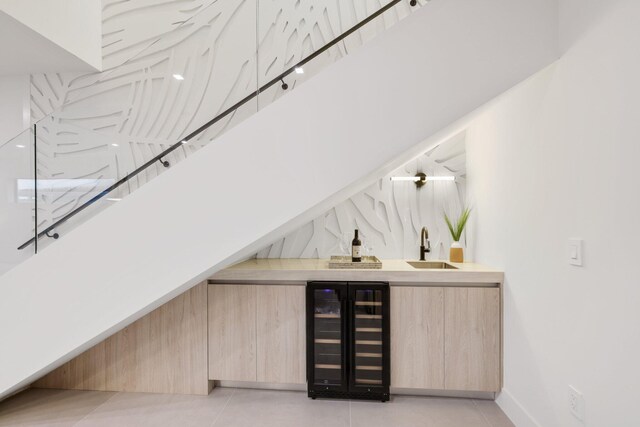 interior space featuring a towering ceiling, indoor wet bar, beverage cooler, and light tile patterned floors