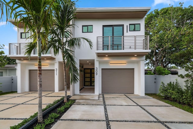 contemporary home featuring a balcony and a garage