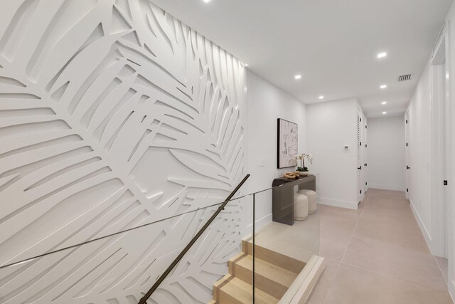 stairway with tile patterned floors