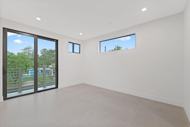 spare room with plenty of natural light and light tile patterned floors