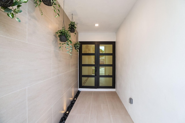 hallway featuring light tile patterned floors