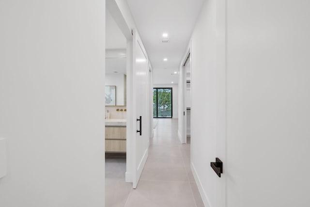 hall with light tile patterned floors