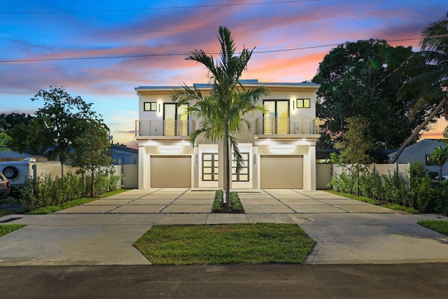 view of front facade featuring a garage and a balcony