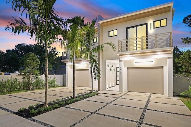 contemporary home featuring a balcony and a garage